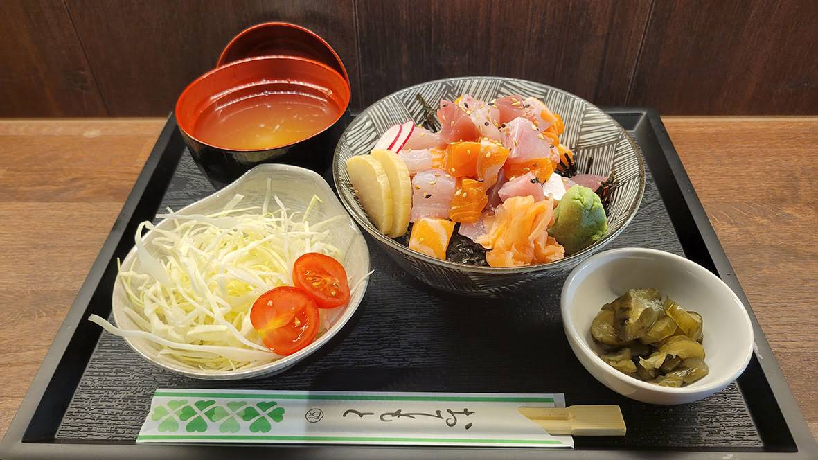 A Japanese set meal with rice, soup, vegetables and a savoury main dish